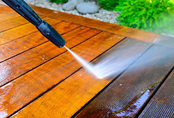 power-washing-service Close up of hose power washing a dirty deck.